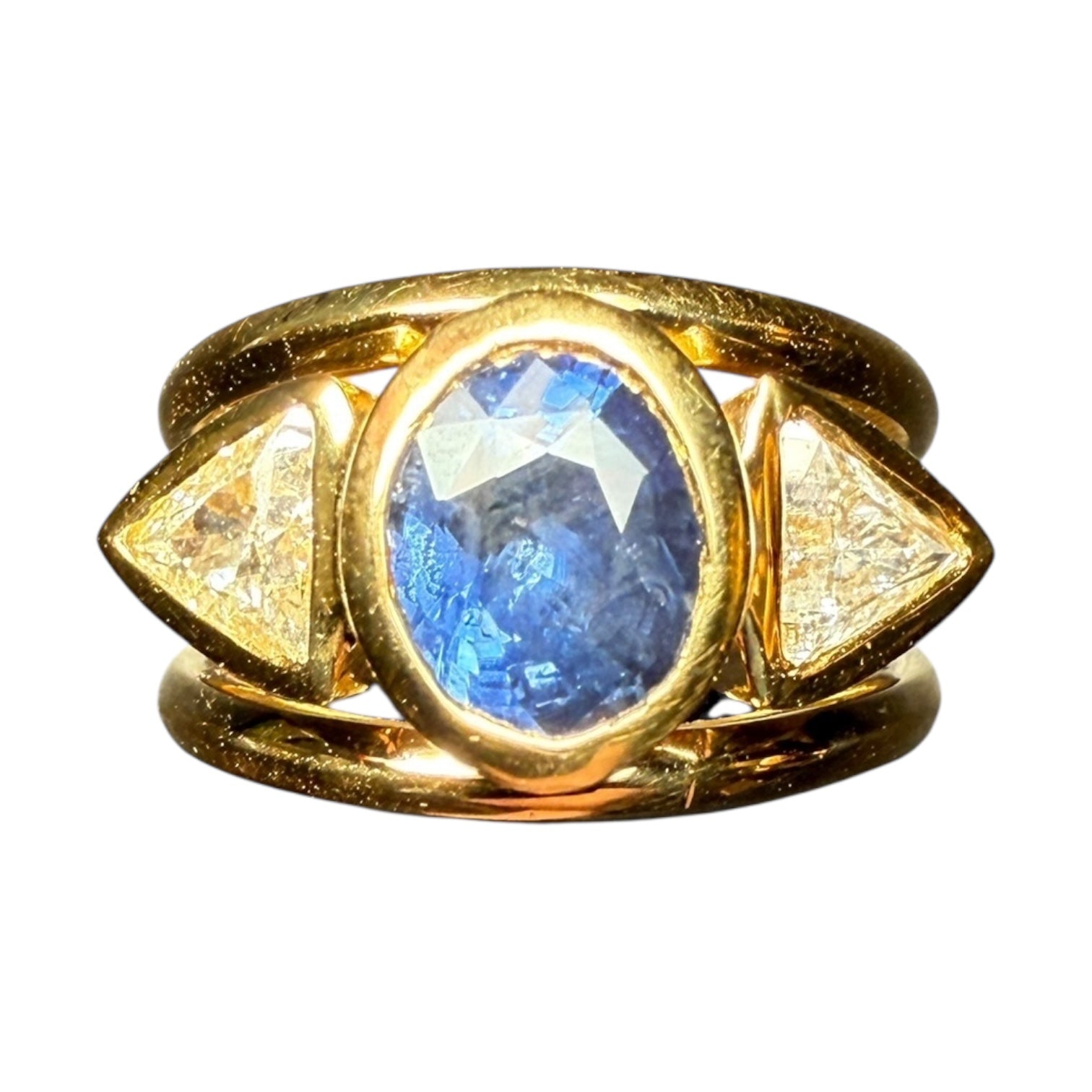 A bold yet refined statement piece, this bespoke ring is handcrafted in solid 9-carat gold and showcases a stunning natural blue sapphire from Tanzania, weighing 2.49 carats. The sapphireGold Ring with Unheated Tanzanian Sapphire and Trillion-Cut Diamonds